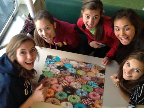 Having barely made the ferry, Wolf netters (l to r) Julia Myers, Allie Hanigan, Micky LeVine, Amanda d'Almeida and Iris Ryckaert celebrate. P.S. -- the donuts aren't real.
