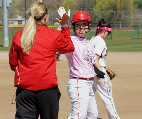 Alexis Trumbull gets a high five after one of her hits. (Shelli Trumbull photos)