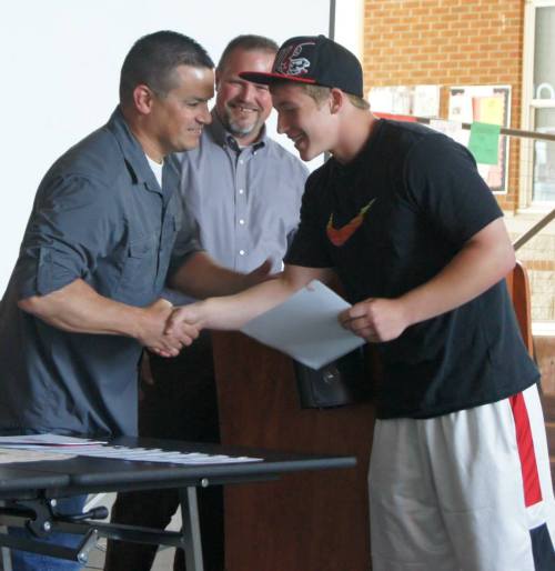 Korbin Korzan gets the handshake o' death from coach Chris Tumblin...