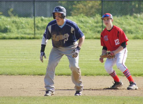 Josh Bayne sneaks behind a runner. A runner who needs to pull his damn pants up.