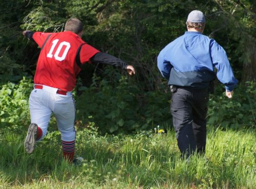 Kyle Bodamer (10) and Randy Payne race to retrieve a fouled-off ball.