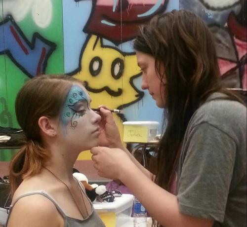 Megan Oakes, also a talented Wolf volleyball player, applies makeup before a performance. (Amanda Rice photo)