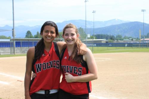 Chevy Reyes (left) and Haley Sherman bask in the sun during the softball playoffs. (Amy King photo)