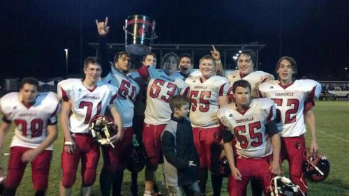 Raymond Beiriger (52) and teammates celebrate beating South Whidbey and reclaiming The Bucket last season.