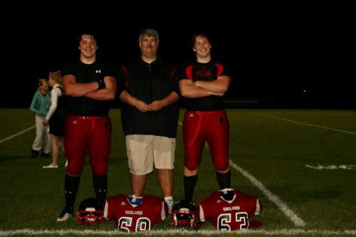 The leaders of the pack, Nick Streubel (left) and Caleb Valko (right) with Wolf football coach Tony Maggio. (Rebecca Lord photo)