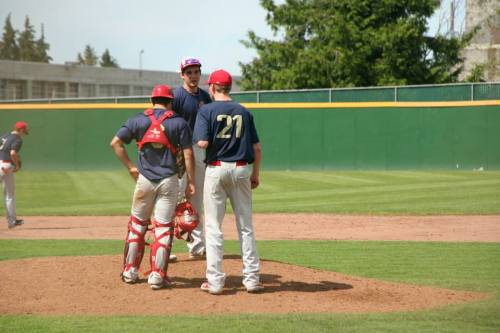 Ben Etzell (middle) holds a mound conference. (Kristi Etzell photo)
