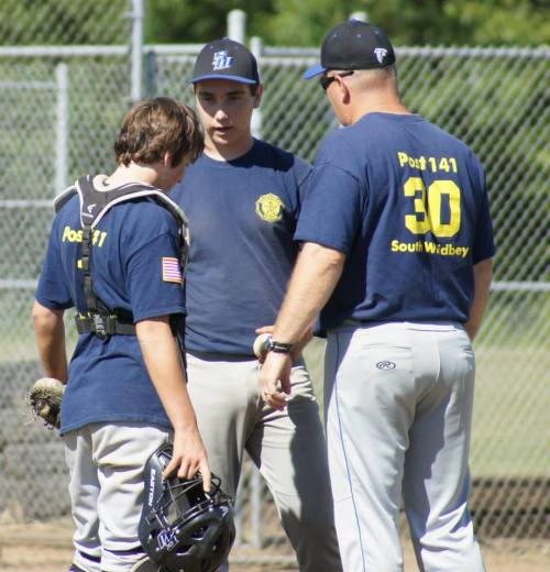 South Whidbey coach Tom Fallon has a mound conference with Wolf hurler Aaron Trumbull and catcher Cole Payne.