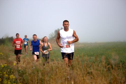Runners sprint through the tall grass at last year's event. (Photos courtesy Marci Ameluxen)