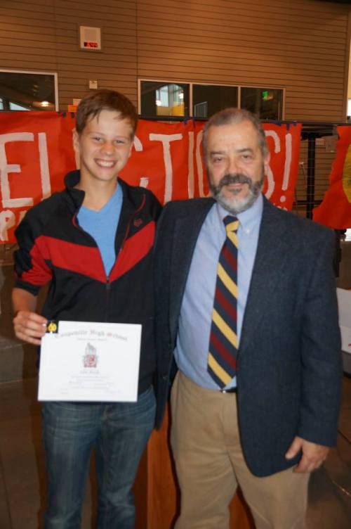 Paul Mendes congratulates one of his final players, CHS freshman Zane Bundy. (Photo courtesy Coupeville Booster Club)