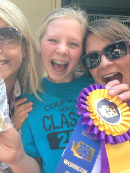 Ally Roberts (center) celebrates her state title with fellow riders. (Laura Houck photo)