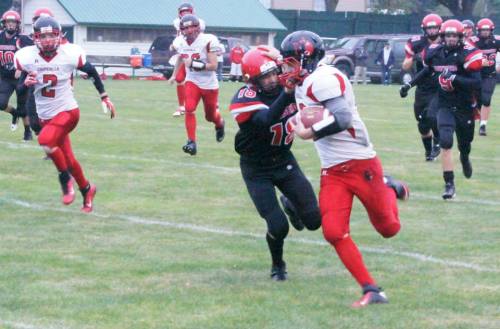 Wolf QB Josh Bayne fights for extra yards in a game against Port Townsend. (Shelli Trumbull photo)