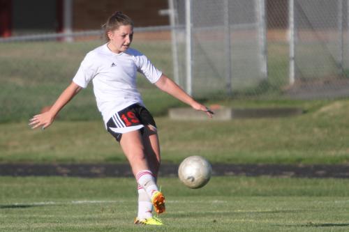 Jennifer Spark clears the ball in an earlier season game. (John Fisken photos)