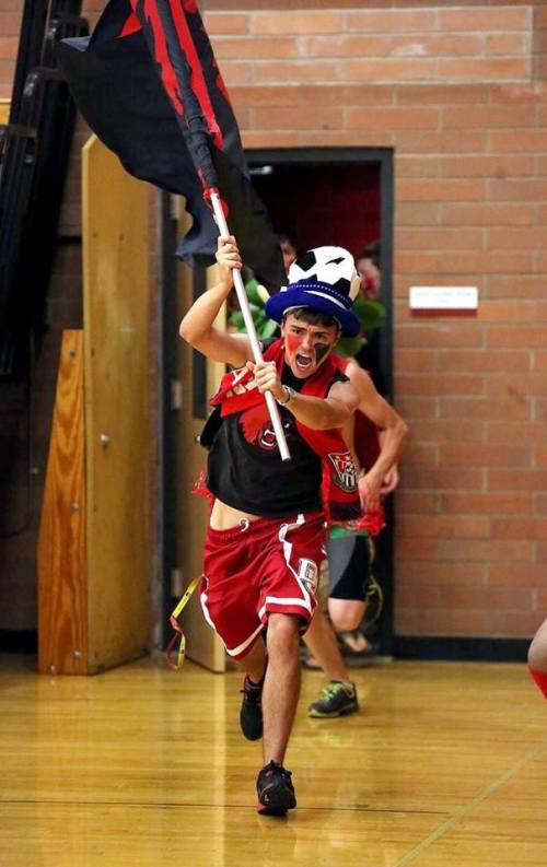 Brian Norris leads the Wolf student cheering section out of the locker room before a recent volleyball match. (John Fisken photo)