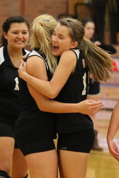Valen Trujillo (right) hugs Tiffany Briscoe while Miranda Engle basks in the glow.