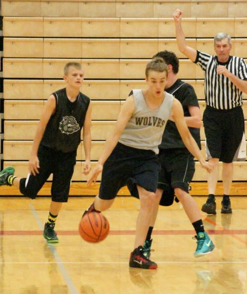 Joel Walstad dazzles two defenders with his nimble dribbling skills.