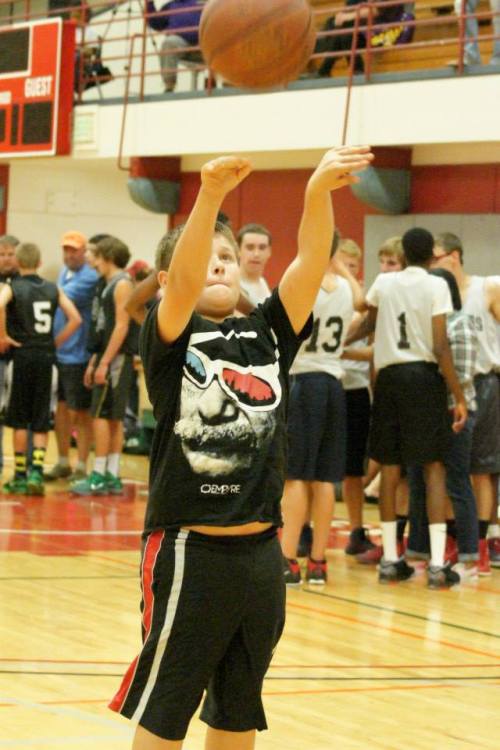 Future Wolf star Skippy Martin warms up the court for the varsity boys.