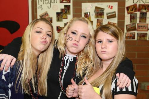 Wolf fans (l to r) Katie Kiel, Emily Clay and Madeline Roberts do their pregame cheering exercises (John Fisken photos).