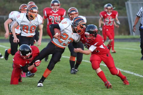 Payne and Jacob Martin (32) team up to bring down a Granite runner.