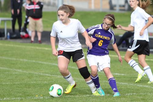 Jennifer Spark blitzes a Concrete defender on her way to a goal.