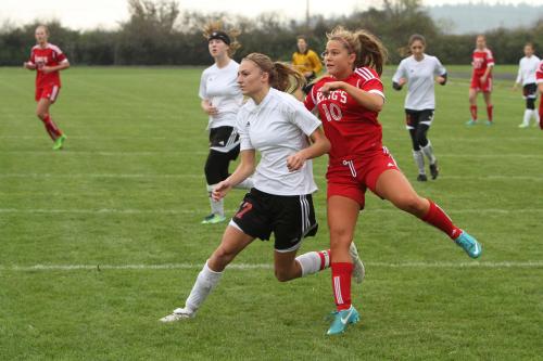 Tori Wellman fights for position against a rampaging King's player.