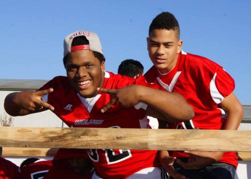 Wolf football players Xavier Clark (left) and Ramon Booker enjoy the parade. (Shelli Trumbull photos)