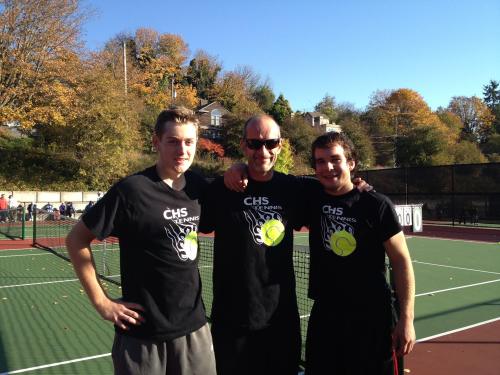Wolf netters Aaron Curtin (left) and Ben Etzell (right) celebrate with coach Ken Stange.