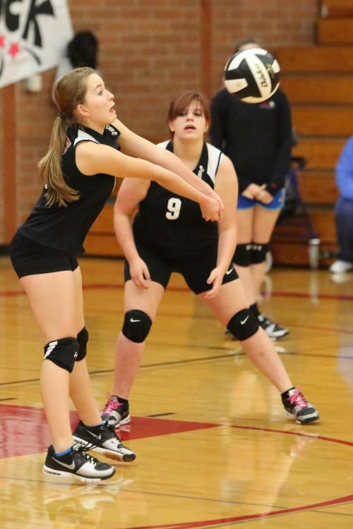 Valen Trujillo (left) and Emily Coulter team up to kick-start the offense in an earlier season match. (John Fisken photo)