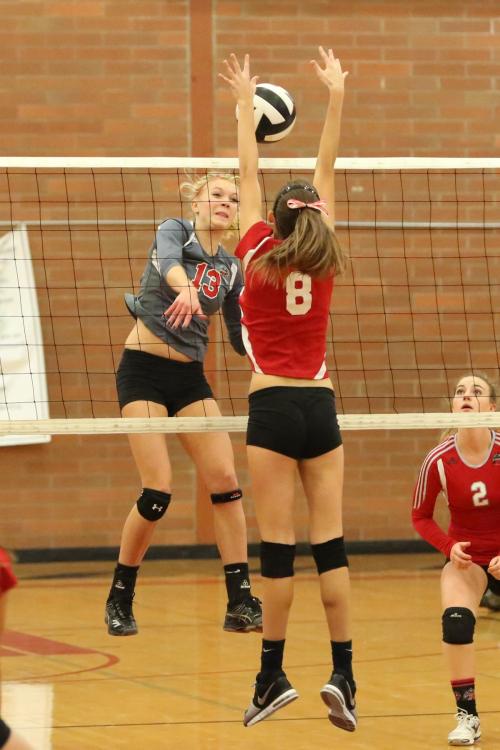 Allie Hanigan (8) touches the sky in an effort to derail the hard-hitting King's offense.