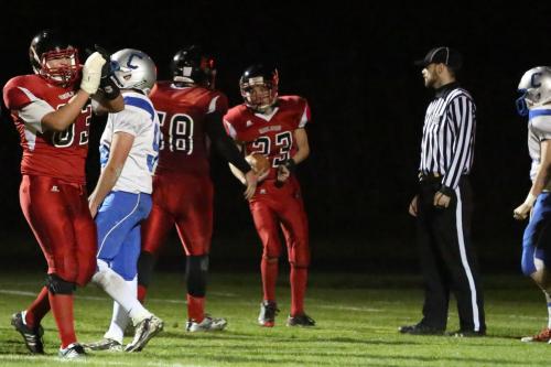 Lineman Oscar Liquidano (63) celebrates as Nick Streubel (68) congratulate Raymond Beiriger, who just scored the first touchdown of his high school career.
