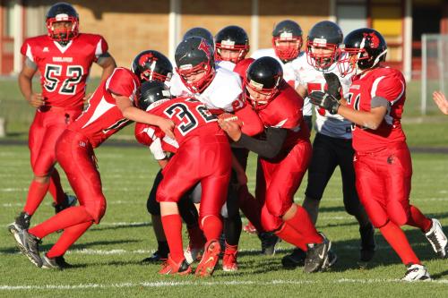 A pack of Wolves descends on the ball carrier.