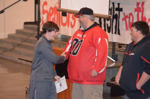 Sophomore Lathom Kelley works the receiving line, glad-handing coaches Tony Maggio and Ryan King.