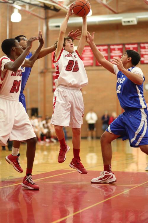 Clay Reilly snags a carom, while Dante Mitchell prepares to come to his aid.