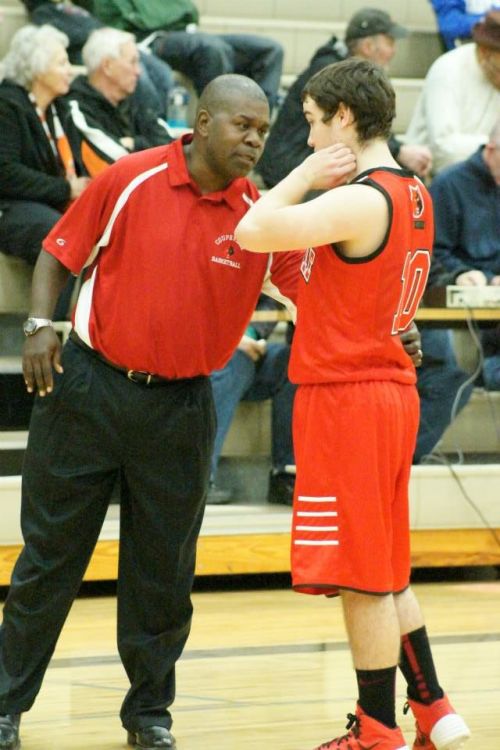 Wolf coach Anthony Smith chats with returning starter Aaron Trumbull.