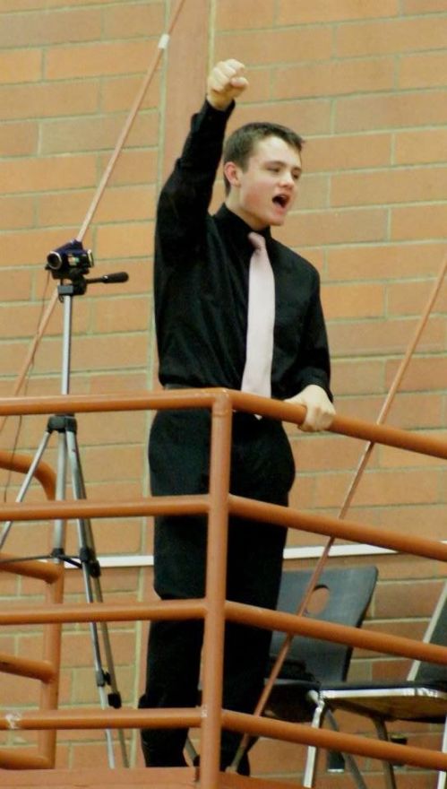 Wolf JV player Grey Rische celebrates up in the video booth.