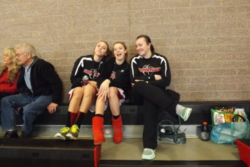 CHS varsity players (l to r) Julia Myers, Kacie Kiel and Hammer carefully monitor the JV game.