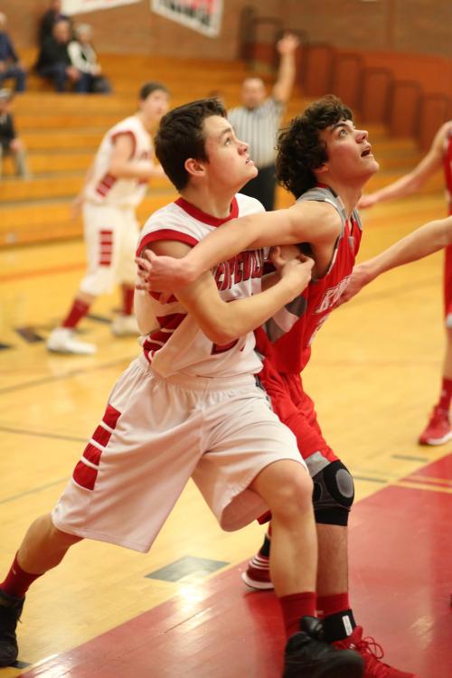 Grey Rische fights for rebounding position with a grabby opponent.