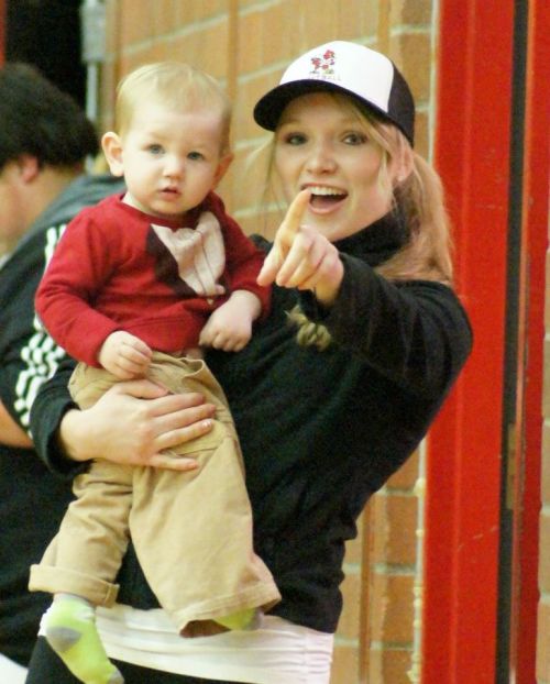 Former Wolf softball ace Alexis Trumbull and her young sidekick enjoy the game.