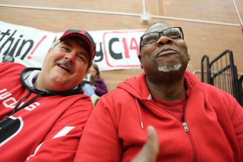 Football coaches scouting for new talent.