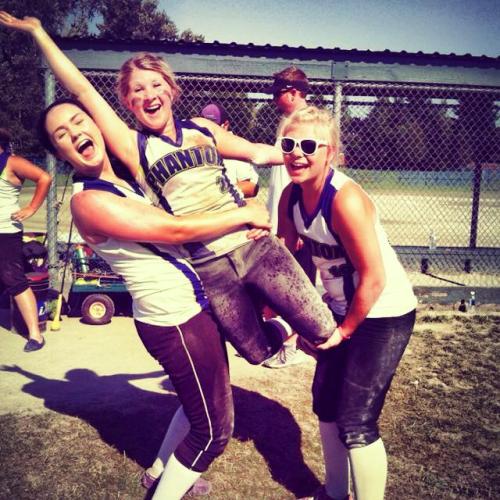 Madeline Roberts (center) celebrates with select softball teammates, including fellow Wolf Madeline Strasburg (right).
