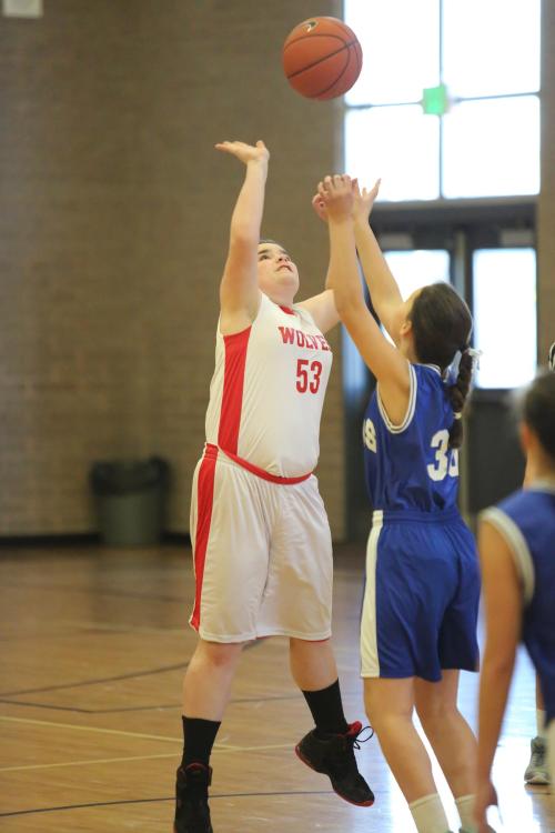 Reaching high for a loose ball.