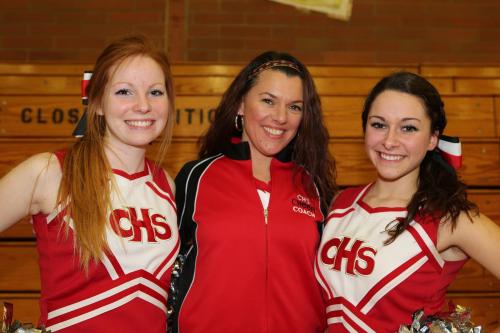 Senior Wolf cheerleaders Shelby Hall (left) and Emilee Crichton pose with coach Cheridan Eck. (John Fisken photos)