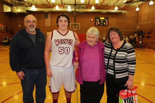 Streubel Tuesday during Senior Night for boys' basketball with his parents and grandmother. (John Fisken photo)