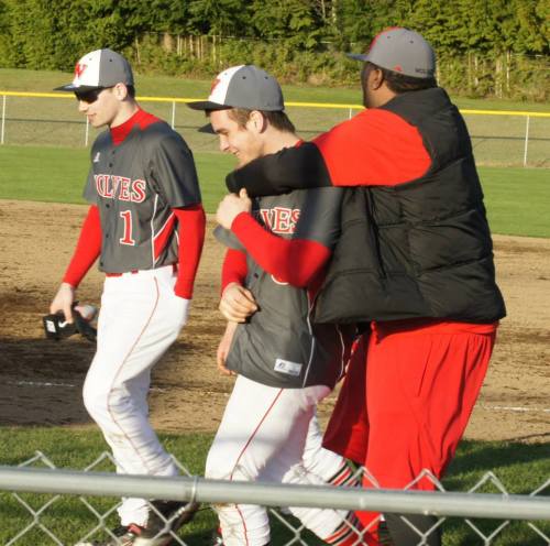 Winning pitcher Ben Etzell gets congrats from a teammate.