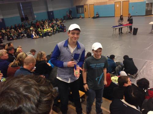 Dion (right) and Sebastian Davis head back to their seat with their district championship medal at this year's Science Olympiad. (Janine Bundy photo)