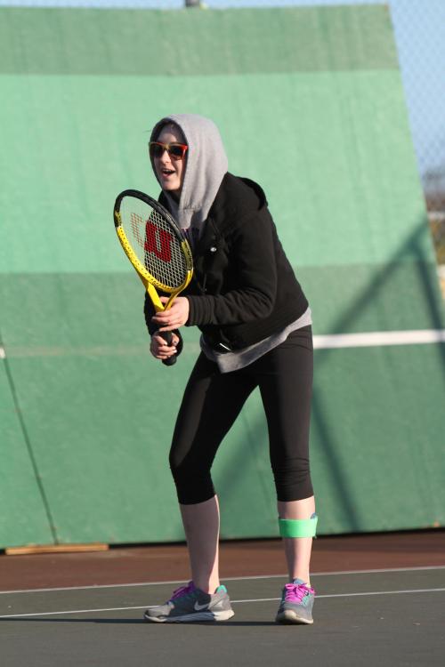 Haleigh Deasy hunkers down against the wind, awaiting the serve.