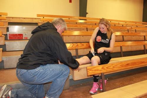 CHS coach David King tapes Messner's ankle before the game. (Amy King photos)