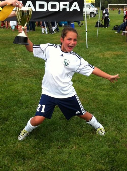 Mia celebrates a soccer trophy in 2011. (Photo courtesy Dawn Hesselgrave)