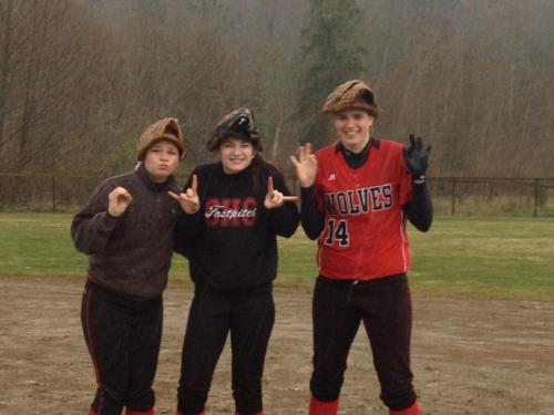 Wolf outfielders (l to r) Madeline Strasburg, Haley Sherman and Monica Vidoni find a second use for their gloves. (Amy King photos)