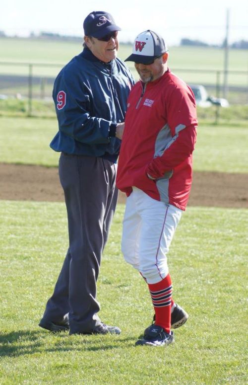 The ol' ball coach, Willie Smith, works his magic with the umps. (Shelli Trumbull photo)