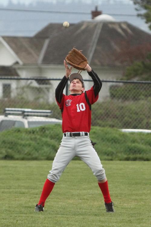Fun with optical illusions, as the baseball appears to be rolling down the rooftop and into the waiting glove of Jimmy Myers. (John Fisken photos)